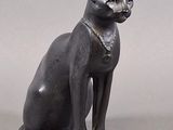 statue of a cat with a collar and a collar around its neck