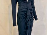 the dress is black and has long sleeves and a v - neck