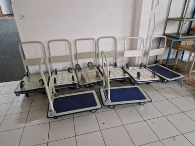 many carts that are sitting on the floor in the room