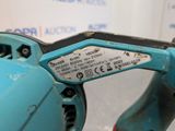 a close up of a blue corded drill with a label on it