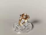a gold ring with a pearl and a diamond on it