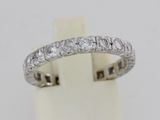 a close up of a diamond ring on a white surface