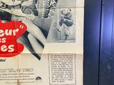 a poster on the door of a building advertising a movie