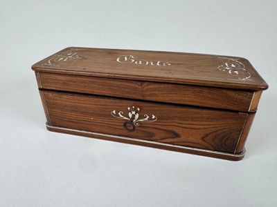an image of a wooden box with writing on the lid