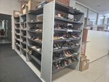 a lot of shoes that are on the shelves in the room