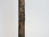 a tall vase with a design on it on a white surface
