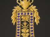 an ornate gold clock with a blue and white face on a black background