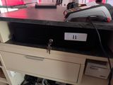 an image of a cash register sitting on top of a filing cabinet