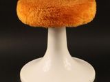 a small white stool with a fuzzy seat on it