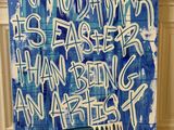 a painting of a blue and white sign with graffiti writing on it