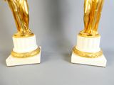 pair of gold and white marble statues of a woman and a man