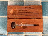 a wooden box with a cigarette in it on a tiled floor