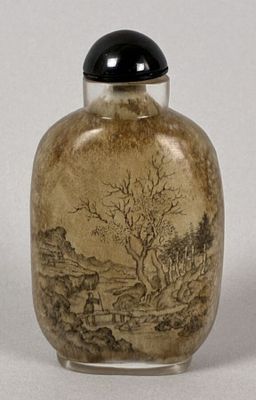 a small glass bottle with a painting on it