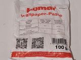 a bag of wallpaper paste sitting on a table next to a pair of scissors