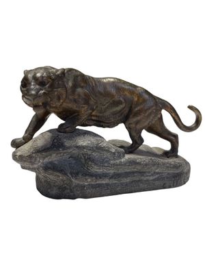 statue of a lion on a rock on a white background