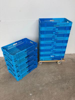two blue plastic crates sitting next to each other on a concrete floor