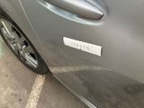 a close up of a car door handle with a sticker on it