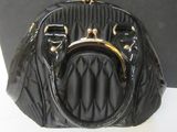 a black purse that is sitting on a table