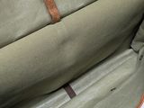 the inside of a green bag with a brown handle