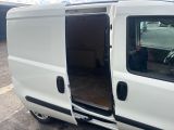 a white van with its doors open in a parking lot