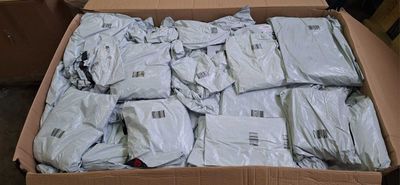 a cardboard box full of white shirts in a room