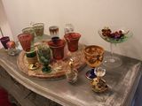 a table with a tray of wine glasses and a tray of fruit on it