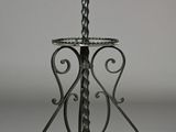 a metal table with a candle holder on it