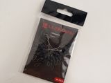 a small package of fishing hooks on a white surface