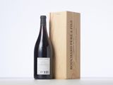 a bottle of wine sitting next to a wooden box