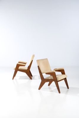 pair of lounge chairs in the style of person, designed by person