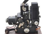 un vieux projecteur de cinéma posé sur une caisse en bois