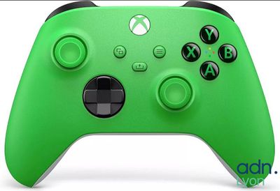 a close up of a green xbox controller on a white background
