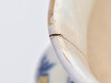 a close up of a vase with blue flowers on it