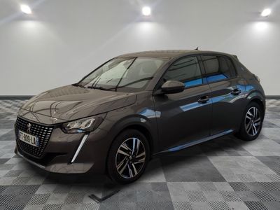 the grey car is parked on a checkered floor in a garage