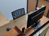 a desk with a computer monitor and a keyboard on it