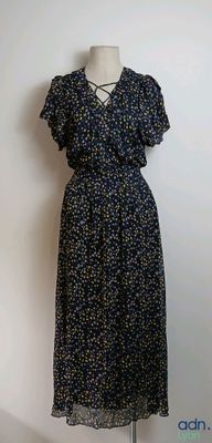 dress made of blue and yellow flowers on a mannequin stand