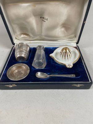 un ancien service d'argenterie présenté dans un coffret, comprenant une cuillère, une cuillère et un repose-cuillère