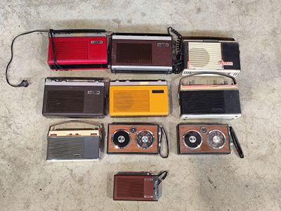 a lot of old radio ' s that are on the floor