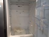 an empty refrigerator with the door open in a kitchen