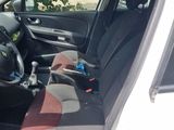 the interior of a car with the door open and the driver ' s seat down