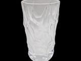 a glass cup that is sitting on a table