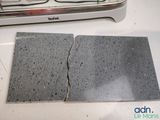 two pieces of concrete sitting on a counter next to a toaster