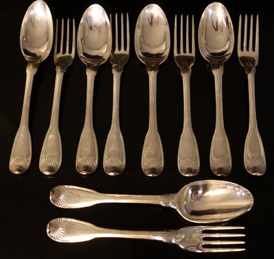 six silver spoons and six silver spoons on a black surface