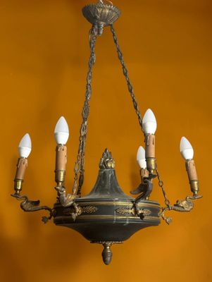 a chandelier with five lights hanging from it ' s ceiling