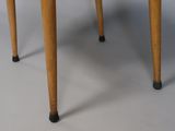 a small wooden table with two legs and a wooden top