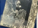 an old photo of a blue folder with a map on top of it