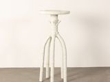 an image of a white stool sitting on top of a cement floor