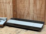a black and white television sitting on the floor next to a wooden wall