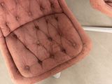 two pink chairs sitting next to each other on the floor