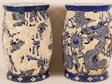pair of blue and white vases sitting on a white surface